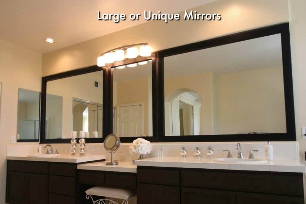 large bathroom mirror divided into three sections with a bathroom mirror frame kit.